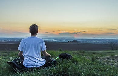 Young man watching the sun rise