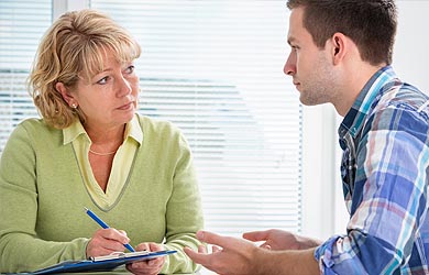 Carer speaking to young man